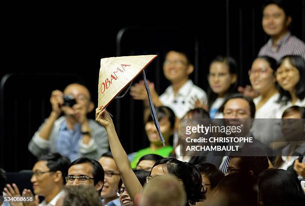Woman holds up a Vietnamese hat with Obama written on it as US President Barack Obama speaks at a Young Southeast Asian Leaders Initiative town hall...