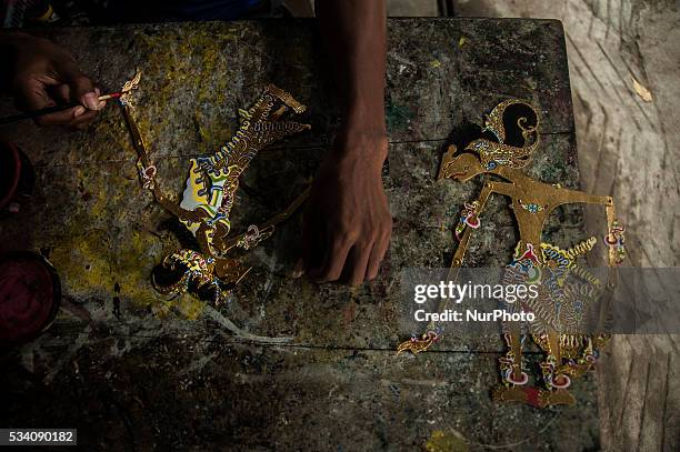 Worker making shadow puppets in Wukirsari, Imogiri, Bantul, Yogyakarta, Indonesia on May 23, 2016. Shadow puppets are made of buffalo skin an...