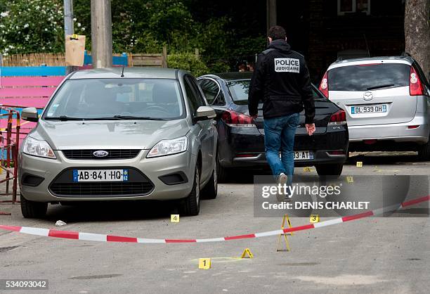 Policemen are at work, on May 25, 2016 in Lille at the scene where a man was shot dead by policemen during an anti-drug operation overnight. / AFP /...
