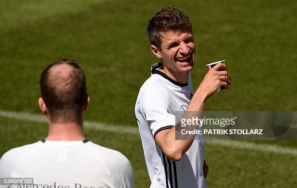 Germany's midfielder Thomas Mueller laughs during a training session as part of the team's preparation for the upcoming Euro 2016 European football...