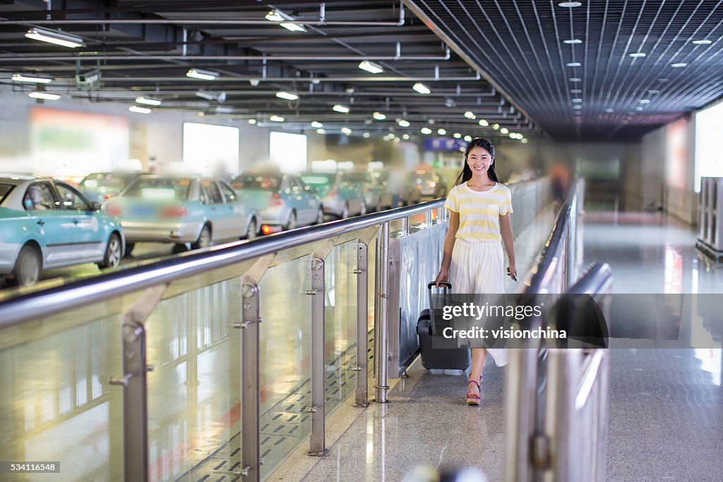 Girl pulling suitcase