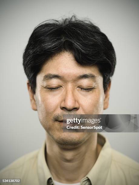 portrait of a japanese man with pensive expression. - korean stock pictures, royalty-free photos & images