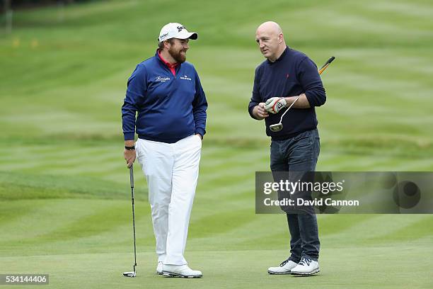 Shane Lowry of Ireland chats with Keith Wood during the Pro-Am prior to the BMW PGA Championship at Wentworth on May 25, 2016 in Virginia Water,...