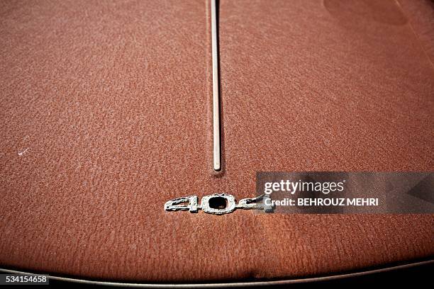 Picture taken on May 25, 2016 shows a close up of an abandoned late 1960s Peugeot 404 car parked at the Sovereign Base Area of Akrotiri, a British...