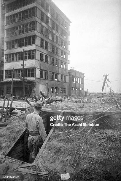 Rescue officer enters an air-raid shelter near the Chugoku Newspapers new building is blown off by the atomic bomb in August, 1945 in Hiroshima,...