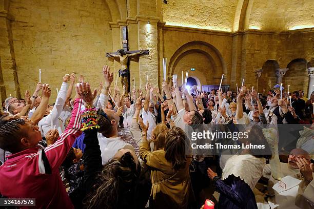 Members congregation and gypsies sing and pray while casket with the reliquary of the local saintes Mary Salome and Mary Jacobe is lifted on May 25,...