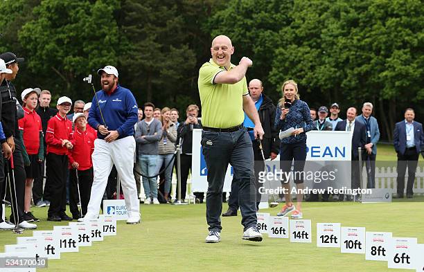 Keith Wood and Shane Lowry of Ireland celebrate in the ISPS HANDA Pressure Putt Showdown prior to the BMW PGA Championship at Wentworth on May 25,...