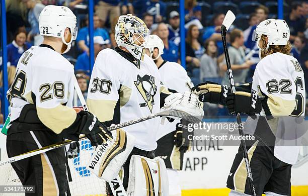 Goalie Matt Murray of the Pittsburgh Penguins celebrates the win against the Tampa Bay Lightning with teammates Ian Cole, and Carl Hagelin after Game...