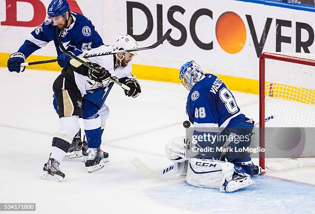 Goalie Andrei Vasilevskiy of the Tampa Bay Lightning makes a save as teammate Braydon Coburn battles against Bryan Rust of the Pittsburgh Penguins...