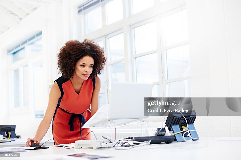 Creative woman working in open plan office.