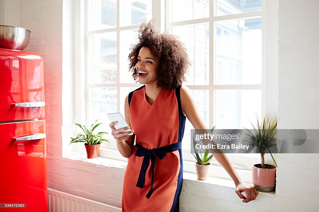 Young woman laughing in a trendy apartment