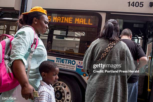 Riders board a METRO bus at the Elm Street station Friday afternoon, May 20, 2016. METRO is expanding service to Yarmouth and Freeport as well as...