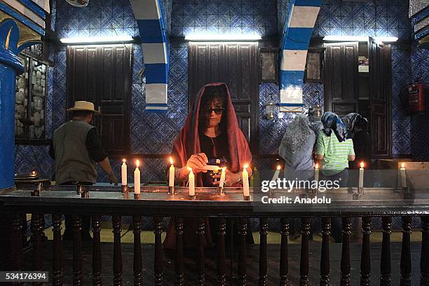 Woman lights a candle as Jews from different countries visit Synagogue La ghriba to celebrate Lag BaOmer in Djerba, Tunisia on May 25, 2016.
