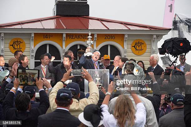 141st Preakness Stakes: Exaggerator owner Matt Bryan victorious, holding up Woodlawn Vase with co-owner Sol Kumin pumping fist after winning race at...