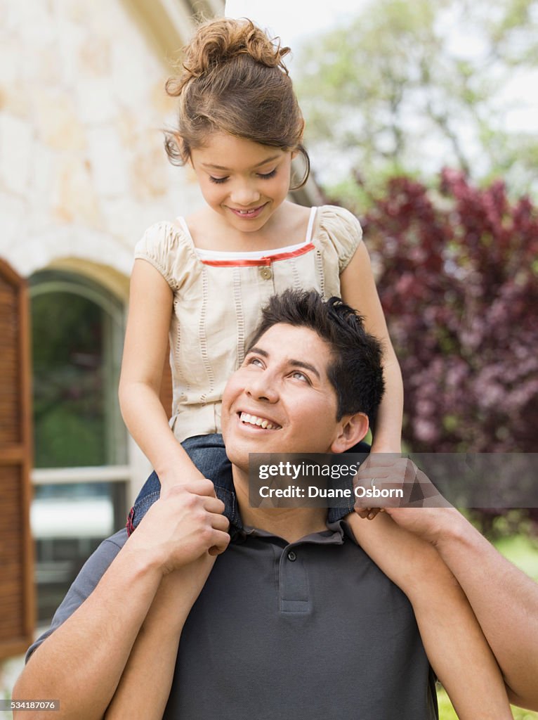 Father giving his daughter a shoulder ride