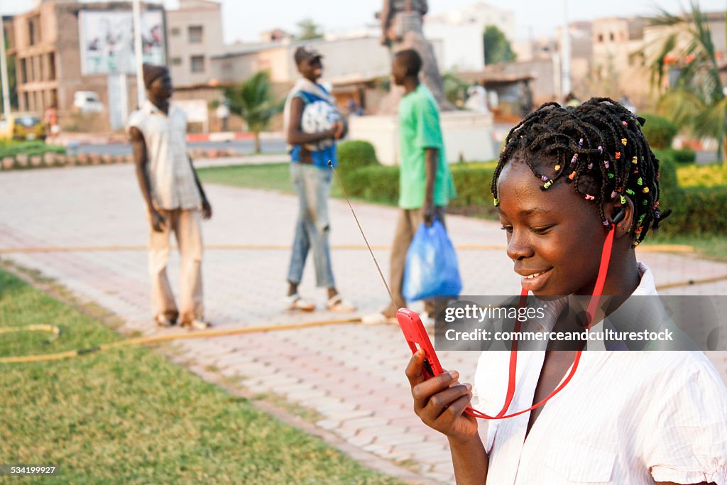 A pre teen girl using a mobile phone