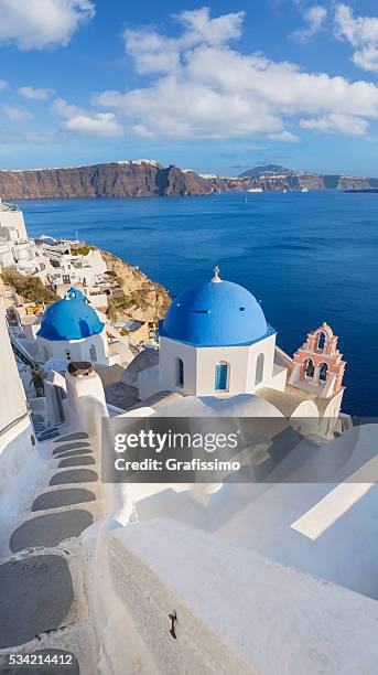 santorini church bell tower and dome in oia on greece - mediterranean-blue-roof-santorini stock pictures, royalty-free photos & images
