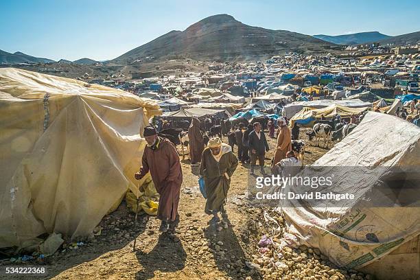 Berber men walk through a livestock market at the Imilchil, Morocco Marriage and Betrothal Festival.