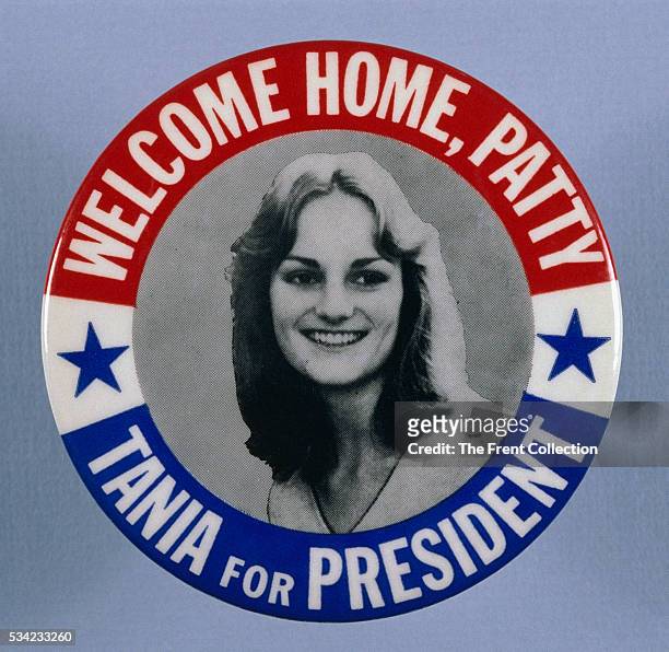 Button shows an image of Patty Hearst along with the phrases 'Welcome Home Patty' and 'Tania for President.' Tania was the name she adopted during...