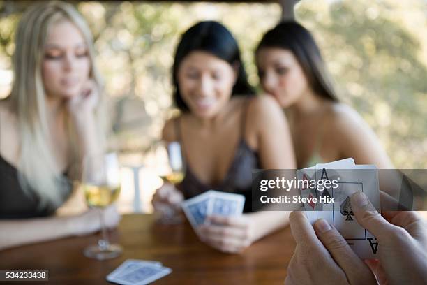 playing poker with a pair of aces - 4 people playing games stock pictures, royalty-free photos & images