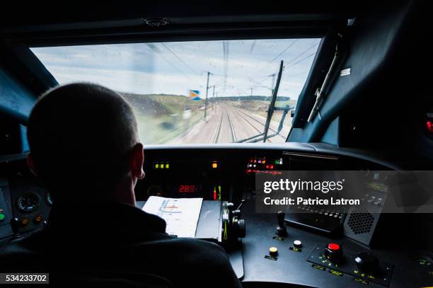 high speed train driver in tgv cockpit - train driver stock pictures, royalty-free photos & images