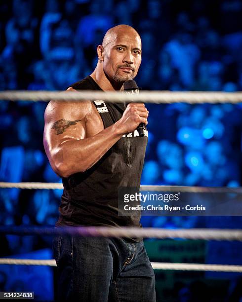 Dwayne Johnson, aka The Rock, enters the ring to talk smack about his upcoming opponent John Cena during the WWE Raw event at Rose Garden arena in...