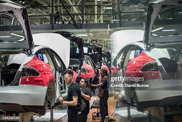 Workers assemble cars on the line at Tesla's factory in Fremont. David Butow