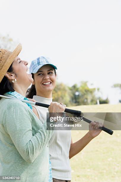 women playing golf - golf polo stock pictures, royalty-free photos & images