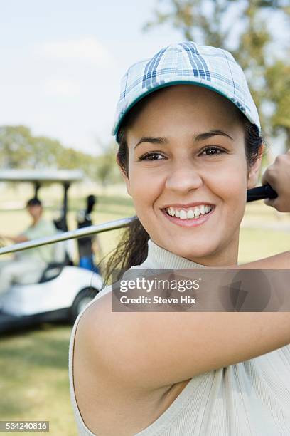 woman playing golf - golf polo stock pictures, royalty-free photos & images