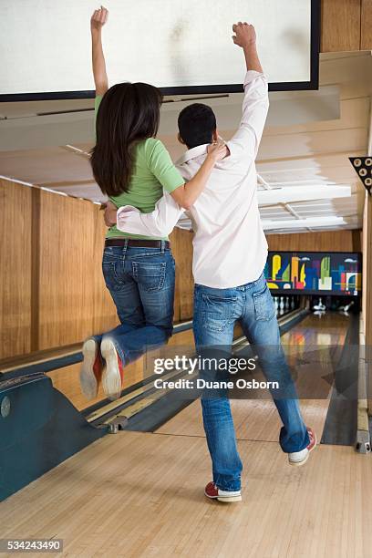 young adults celebrating at bowling alley - bowling woman stock-fotos und bilder