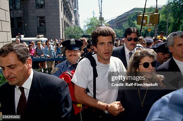 John Kennedy Jr. And Caroline Kennedy Schlossberg wade through a gauntlet of media outside the apartment of their mother Jacqueline Kennedy Onassis...