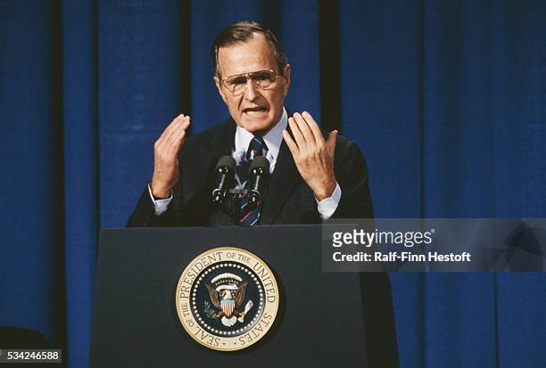 George Bush holds up his hands as he speaks. He was holding a press conference at the Chicago Mercantile Exchange.