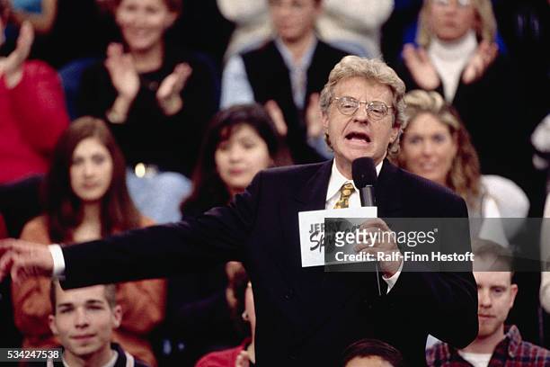 Talk show host Jerry Springer talks to his guests and audience on the set of The Jerry Springer Show. The show is known for its sensational topics...