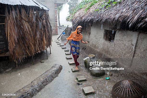 Village girl runs through the rain. Even in the best of times Bangladesh seems plagued by catastrophe. A majority farming base, extreme poverty and...