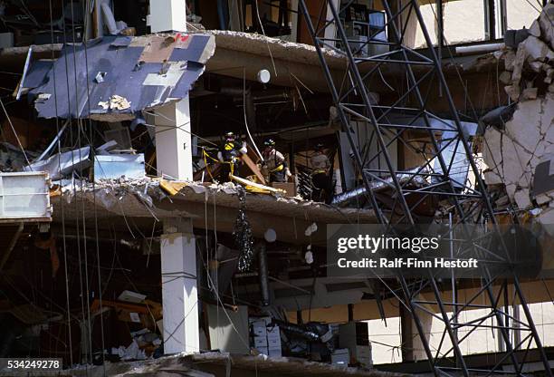 Rescue workers sift through the rubble of the destroyed Federal Building in the aftermath of the Oklahoma City bombing. On April 19th a...