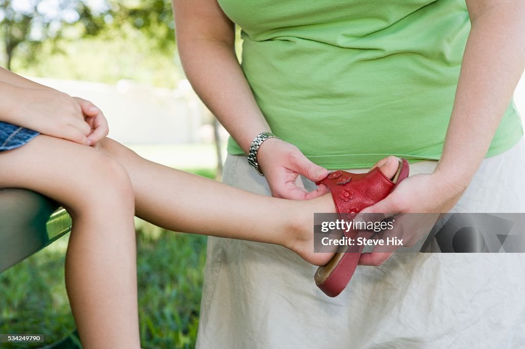 Mother Adjusting Daughter's Sandal