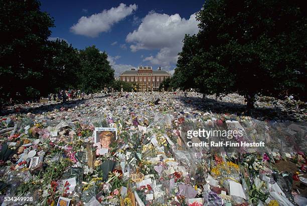 Mourners have left dozens of bouquets, cards, and photographs outside Kensington Palace for the funeral of Diana, Princess of Wales.