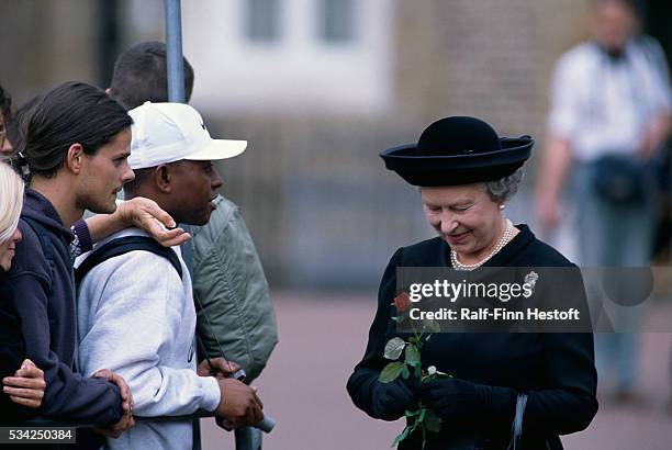 At Princess Diana's funeral, Queen Elizabeth II greets mourners waiting in line to sign the condolence book.