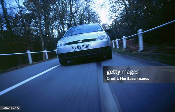 Ford Fiesta driving along country road, 2000.
