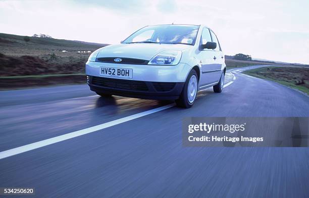 Ford Fiesta driving along country road, 2000.