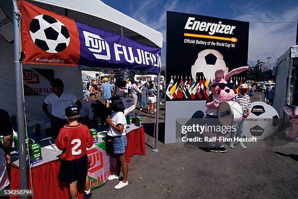 Children visit a Fujfilm stand and and have their photos taken with the Energizer Bunny outside the Rose Bowl during the World Cup. The consolation...