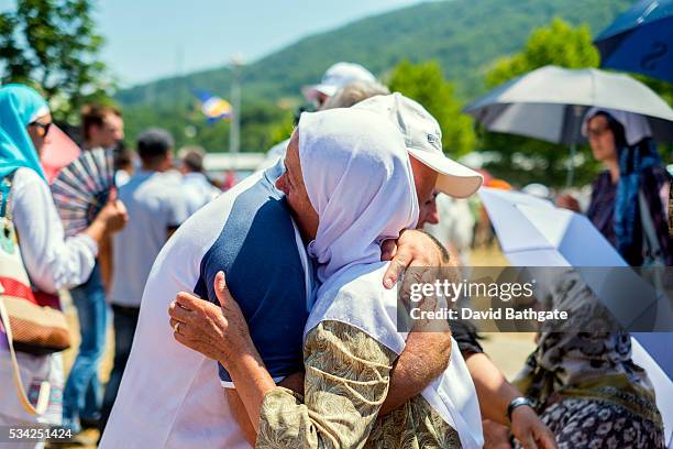 Friends embrace at the Srebrenica-Potocari Memorial and Cemetery.