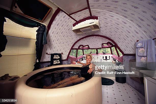 Jo Ann Ussery relaxes in a hot tub inside her converted Boeing 727. Rather than buying a mobile home, Ussery purchased an old Boeing 727 for $2,000...