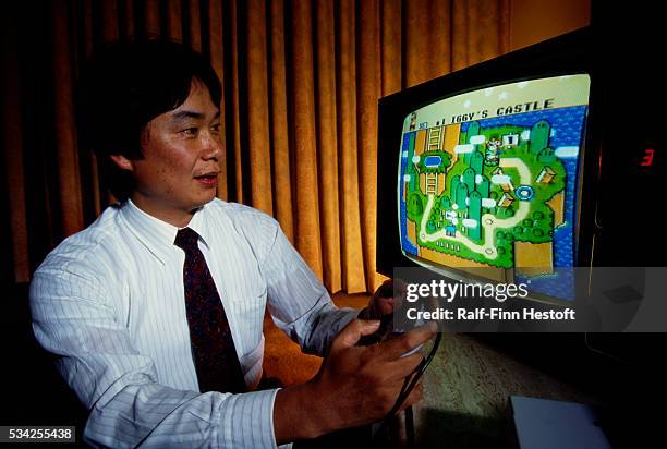 Shigeru Miyamoto, creator of Mario and other characters and video games for Nintendo, plays Super Mario World on a Nintendo Super NES System.