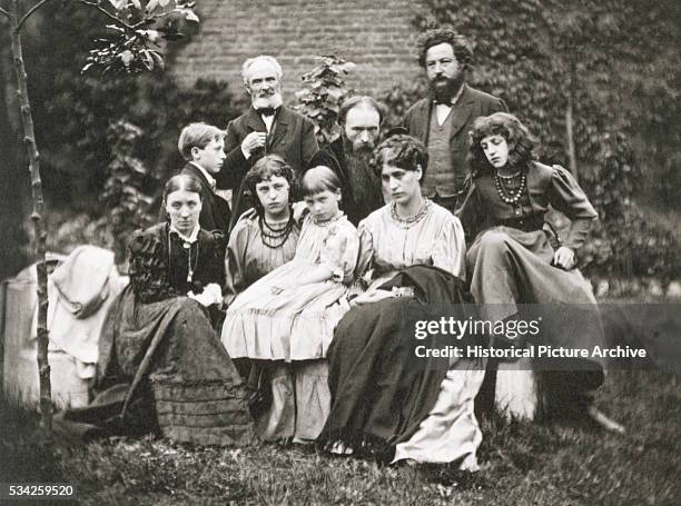 William Morris stands with Sir Edward Burne-Jones and family.