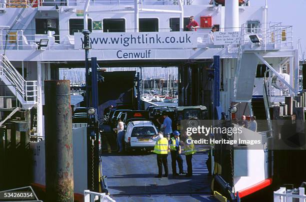 Cars boarding ferry at Lymington bound for Yarmouth Isle of Wight 2000.