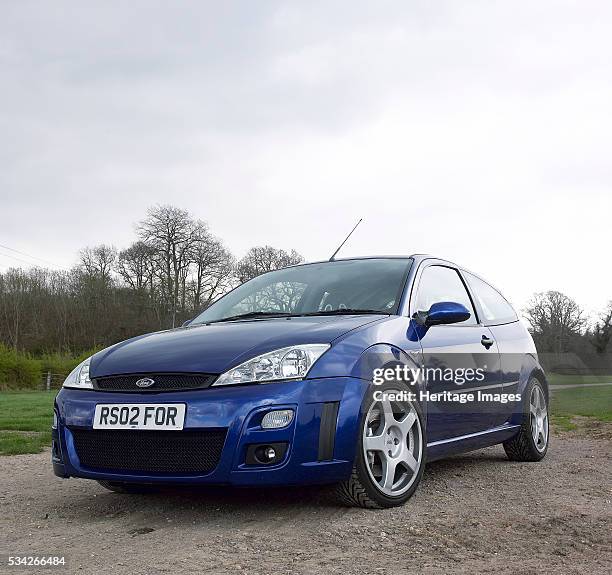 Ford Focus RS driving on country road, 2000.