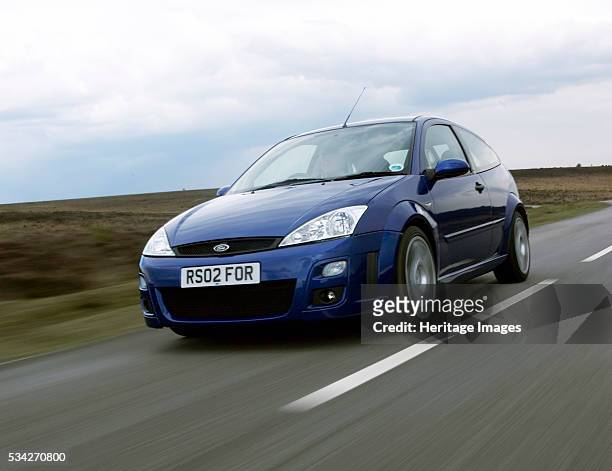 Ford Focus RS driving on country road, 2000.