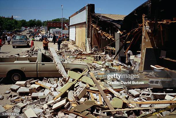 Debris covers a nearby sidewalk in the aftermath of the Oklahoma city bombing. On April 19 Timothy McVeigh exploded a truck bomb outside of the...