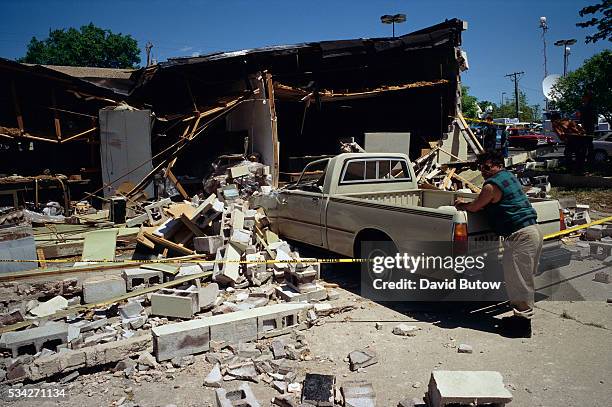 Debris covers a nearby sidewalk in the aftermath of the Oklahoma city bombing. On April 19 Timothy McVeigh exploded a truck bomb outside of the...